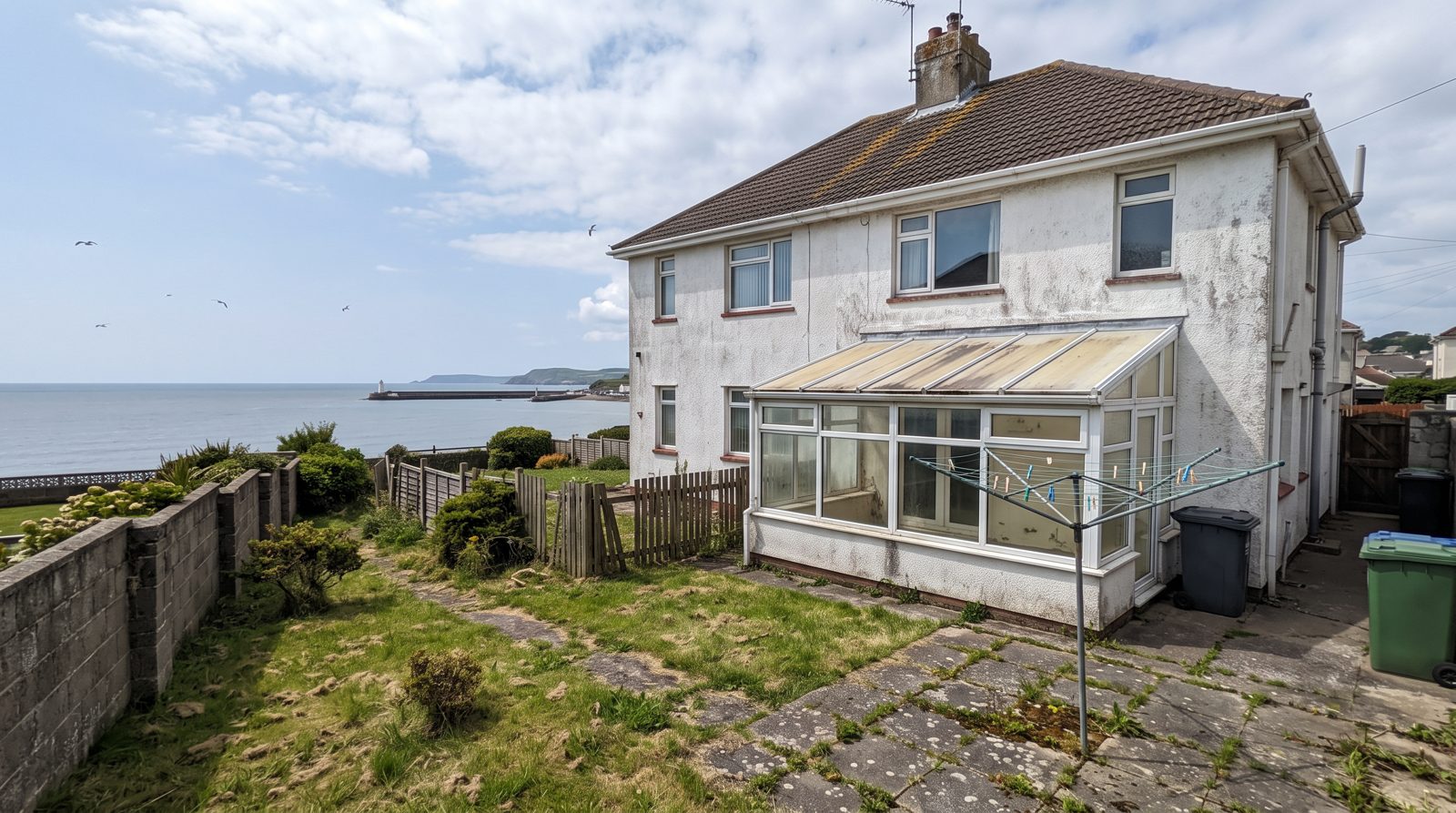 The house before — tired lean-to conservatory