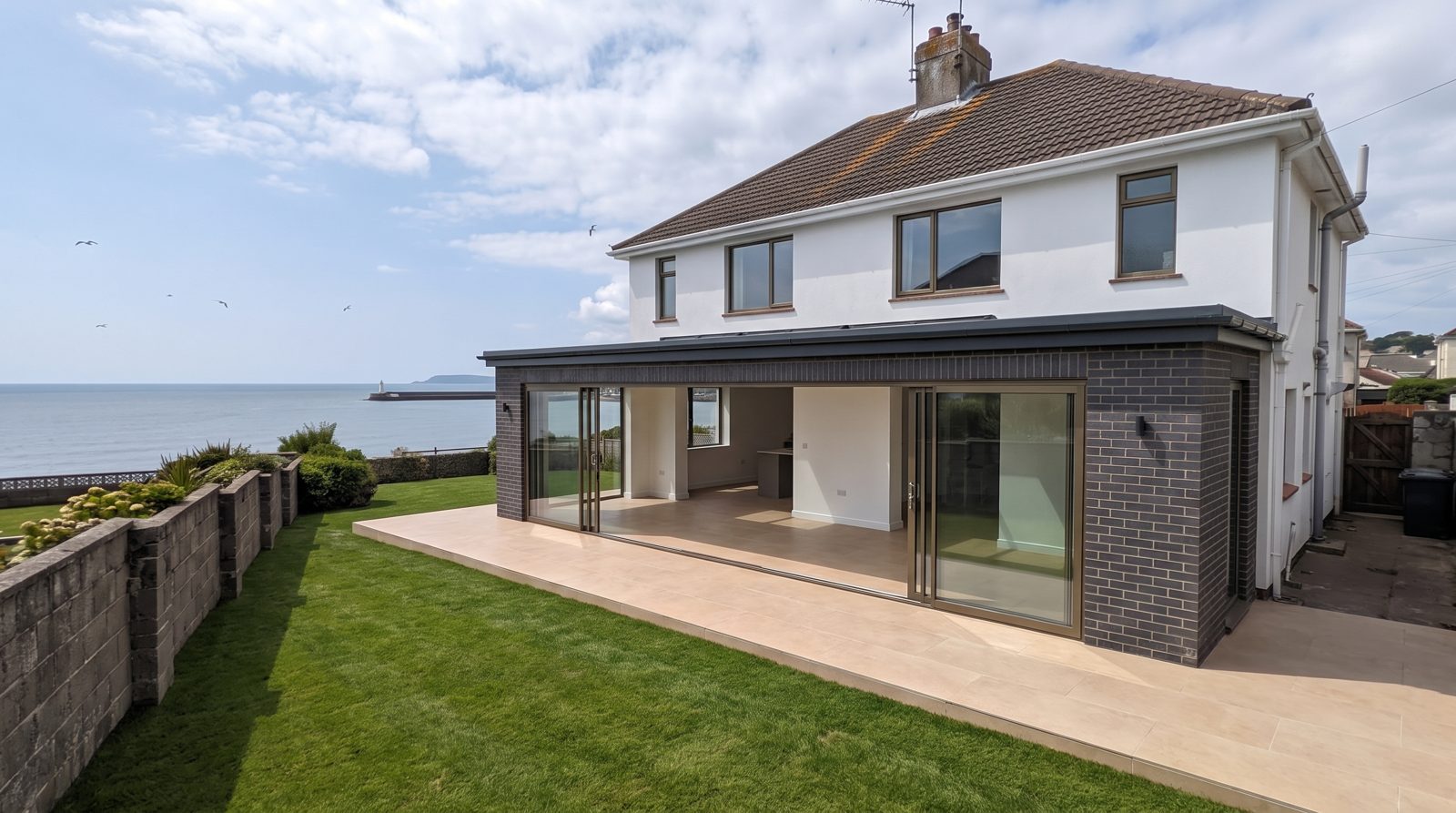 The Bronze — charcoal brick extension with bronze-framed glass